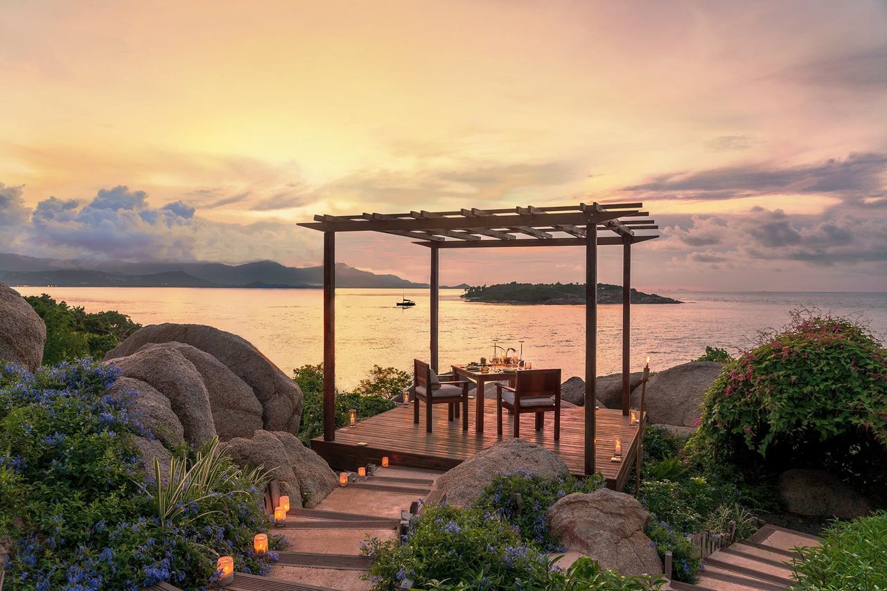 A table for two on a clifftop deck at Six Senses Samui