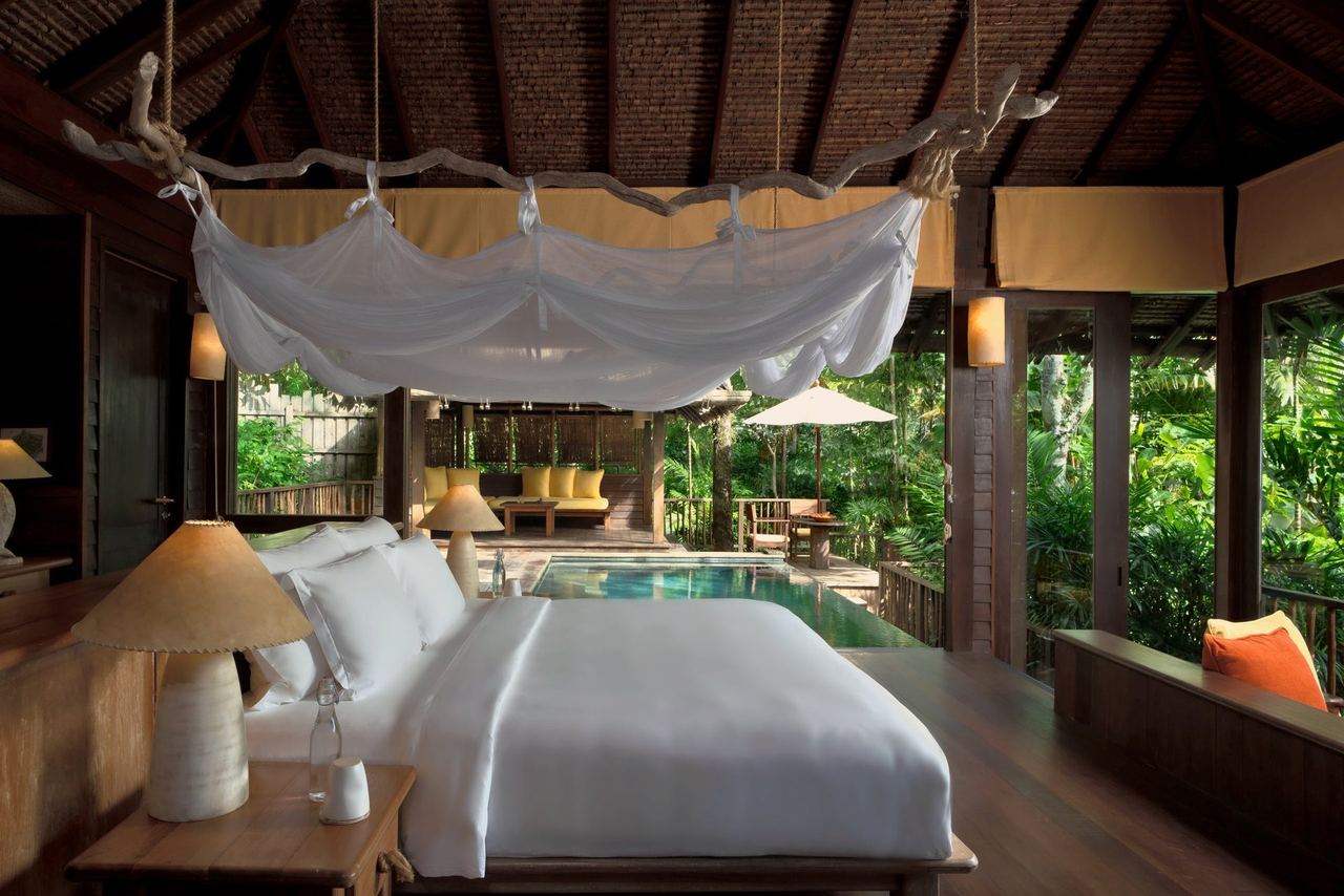 A pool villa bedroom at Six Senses Yao Noi under a timber roof