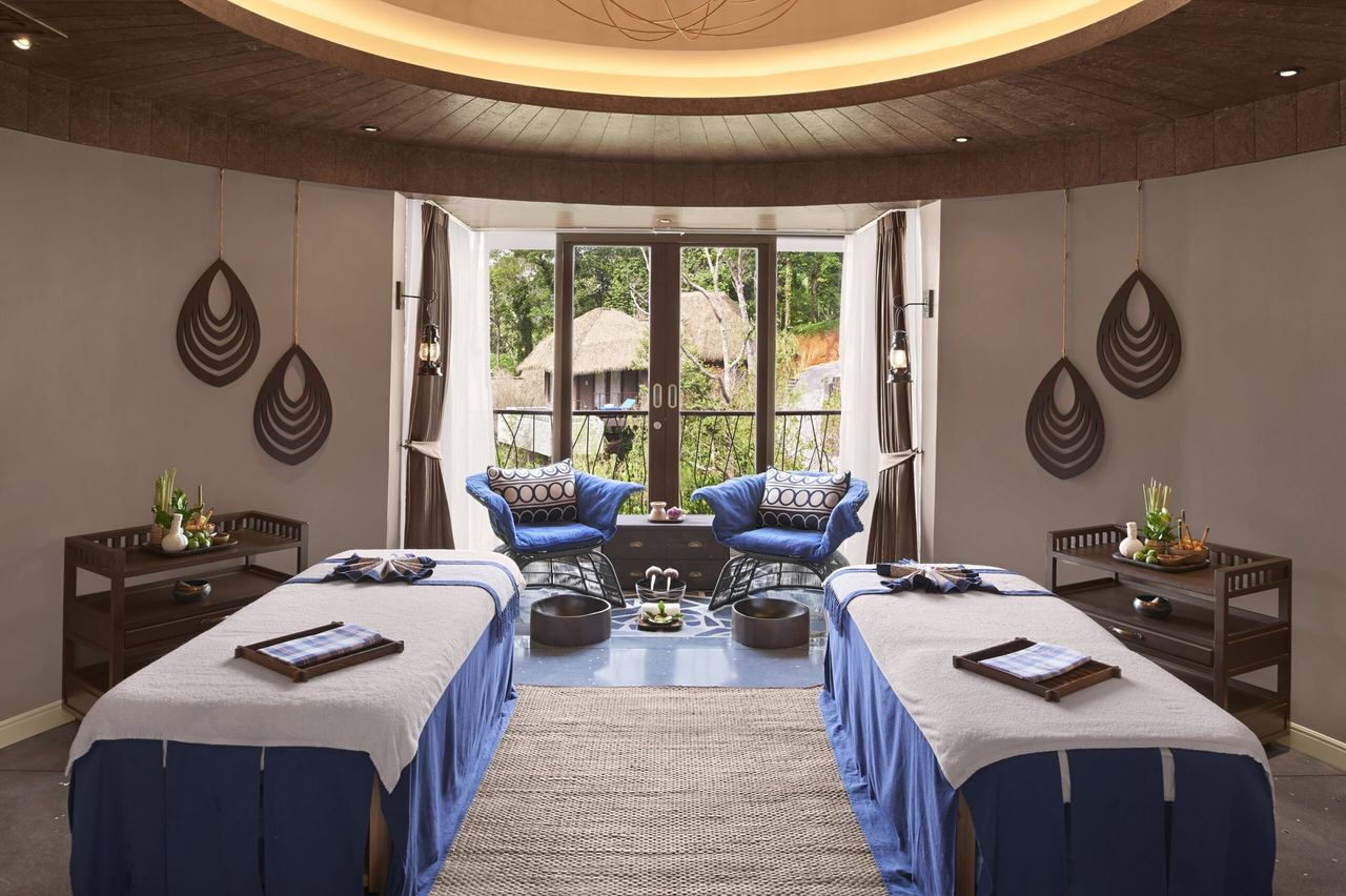 A double treatment room at Keemala’s spa, opening onto the trees and thatched villas