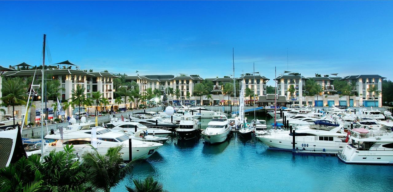 Motor yachts in the basin at Royal Phuket Marina, with the marina buildings behind
